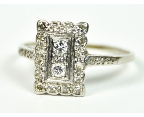 A Platinum Diamond Shield Ring, Early 20th Century, pave set with small brilliant cut white diamonds, 14mm x 10mm, flanked by