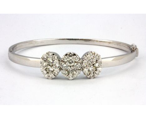 An 18ct white gold (stamped 750) bangle set with approx. 3ct of brilliant cut diamonds, L. 5.5cm.
