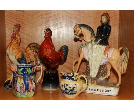An early 19th century Staffordshire flatback figure (repair to neck), two early jugs and two ceramic cockerels.