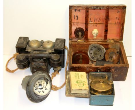 A military box, field telephone, compass and other items.