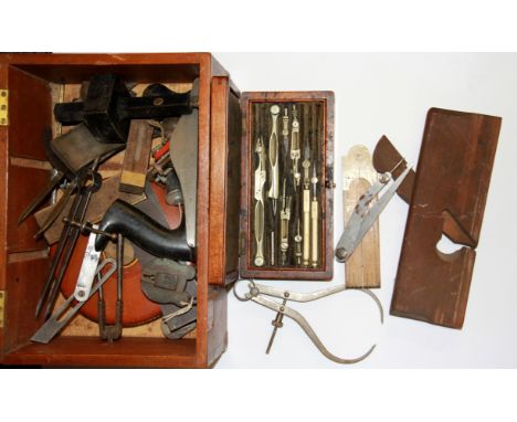 A mahogany box of mixed tools and drawing instruments.