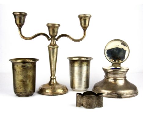 A hallmarked silver Capstan inkwell, Dia. 12cm together with a three branch silver candelabrum, hallmarked silver napkin ring