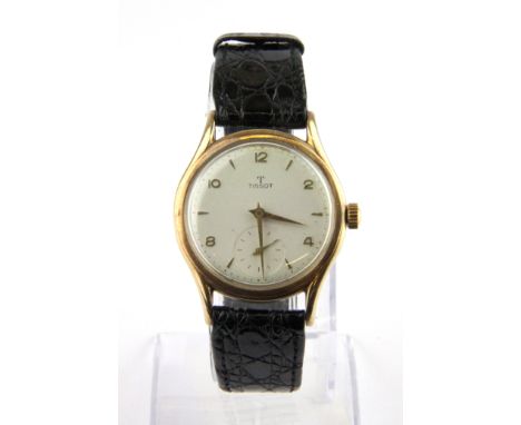 A gents Tissot 14ct yellow gold wrist watch on a leather strap.
