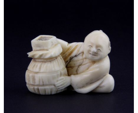 A 19th Century Japanese carved ivory netsuke of a grain seller, H. 3cm.