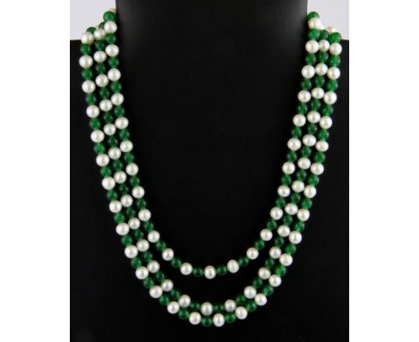 A three row jade and cultured pearl necklace on a white metal clasp.