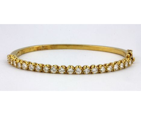 An 18ct yellow gold (stamped 750) bangle set with brilliant cut diamonds, approx. 3ct overall, Dia. 6cm.