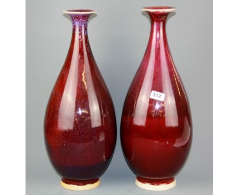 A pair of large 20th century Chinese Sang de boeuf glazed ceramic vases, H. 52cm.