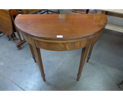 A George IV inlaid mahogany demi-lune fold over card table 