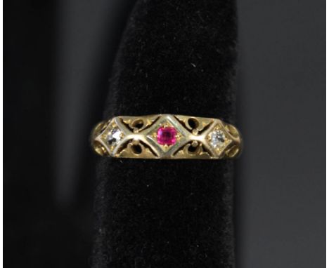 An 18ct gold ruby and diamond ring in ornate pierced setting, size K