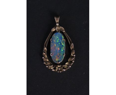 A large 9ct gold pendant with floral decoration with oval shaped opal doublet to centre