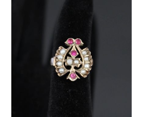 A yellow metal ring set with seed pearls and pink stones size M