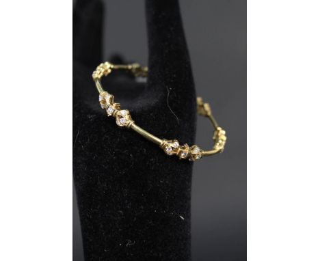 A yellow metal diamond set bangle marked 18ct, diamond weight approx 1.5ct