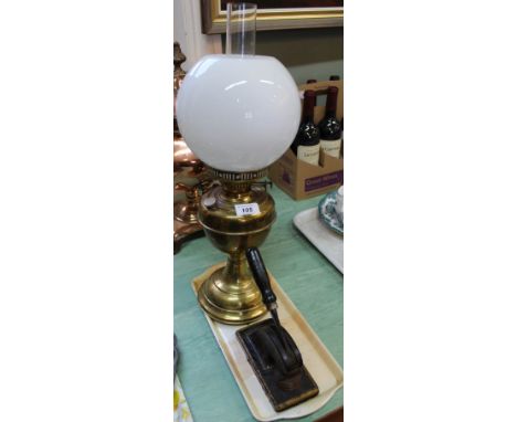 A brass oil lamp and stamper