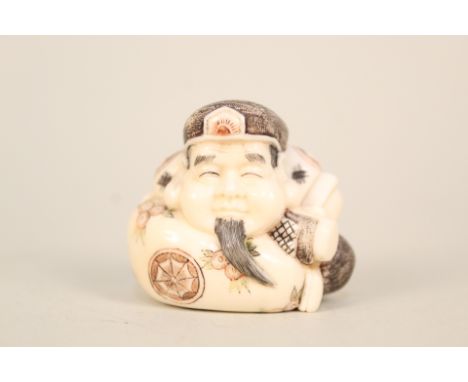 A Japanese ivory netsuke of a squat man with incised and painted decoration, signed