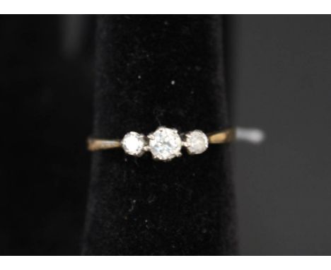 A yellow metal three stone diamond ring, size R