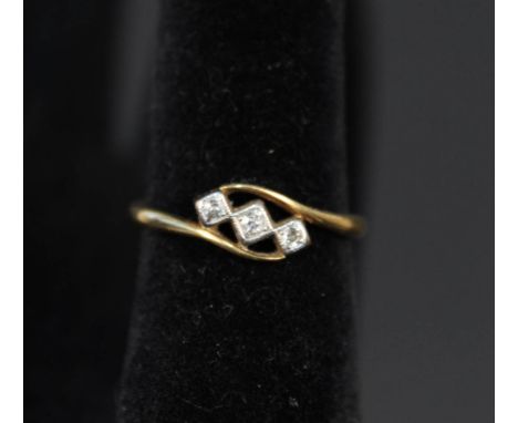 An 18ct gold Art Deco style three stone diamond ring, size R