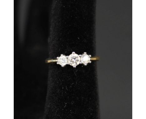 An 18ct gold three stone diamond ring, total diamond weight approx 0.75cts, size N