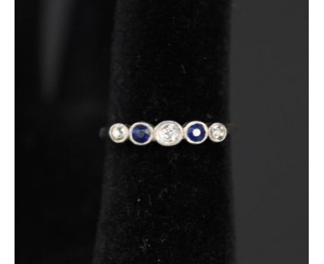 An 18ct gold five stone sapphire and diamond ring, size O