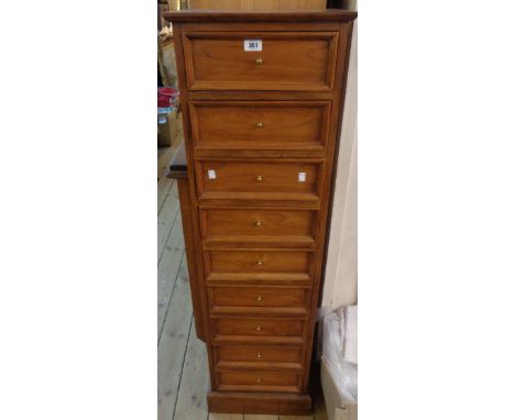 A 15 1/2" 20th Century polished walnut flight of nine drawers with moulded fronts, set on plinth base
