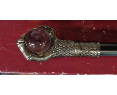 A modern walking stick with a ball and claw top