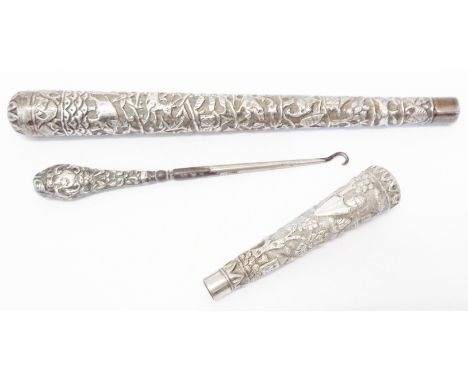 Two Anglo Indian ornate white metal parasol handles with profuse embossed decoration - sold with a silver handled button hook
