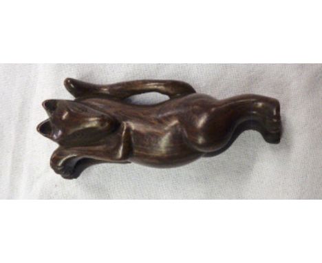 A carved wood netsuke of a reclining fox - signed