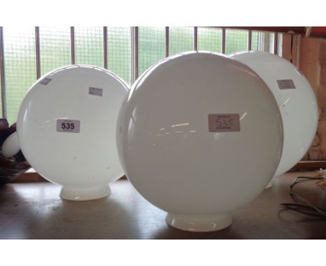 A pair of milk glass globular lamp shades and a larger similar