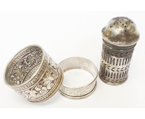 A Victorian silver ornate napkin ring, another and a later pepperette with blue glass liner