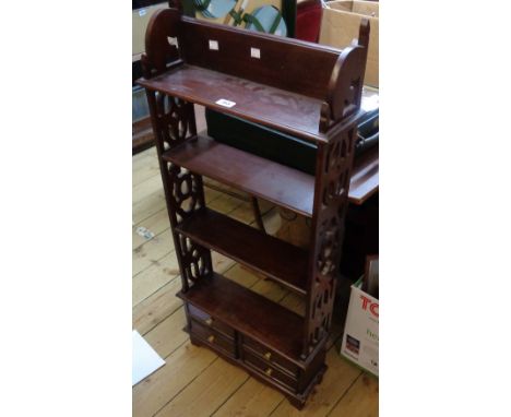 A 19 3/4" Eastern hardwood four shelf open bookcase with pierced standard ends and four short drawers under, set on bracket f