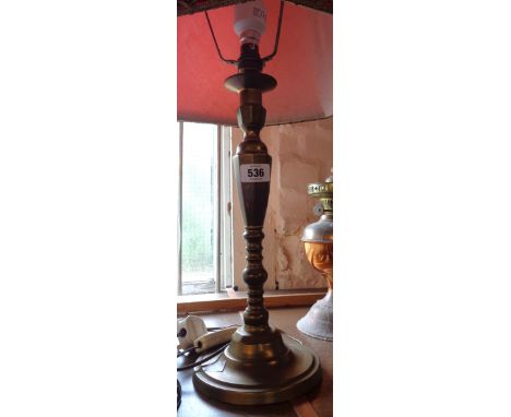 A brass table candlestick pattern lamp with shade