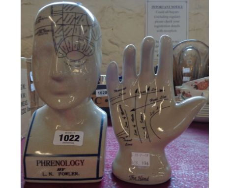 A modern reproduction ceramic phrenology head and palmistry hand