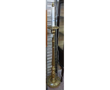A decorative ornate gilt torchere style standard lamp with shade