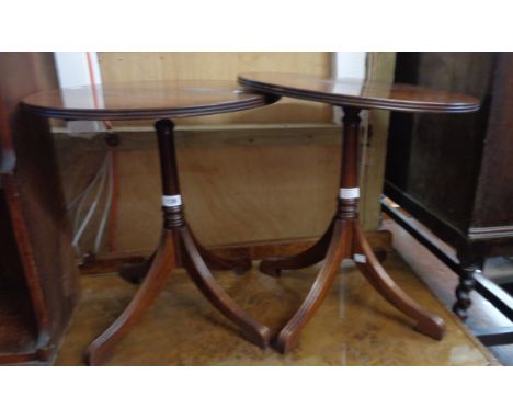 A pair of reproduction mahogany circular pedestal tables, each set on turned pillar and quadruple reeded splayed legs