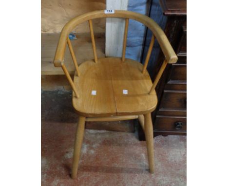 A vintage blonde wood child's bow high chair