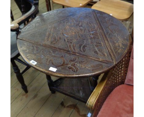 A 29 1/2" diameter incised oak drop-leaf occasional table with foliate scroll decoration to top and triangular undertier, set