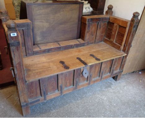 A 4' 11" Indian rosewood Pitara sofa with iron strapwork and flanking rings, rough hewn finials and all round panelling, set 