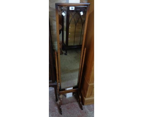 A vintage polished oak framed cheval mirror, set on splayed legs