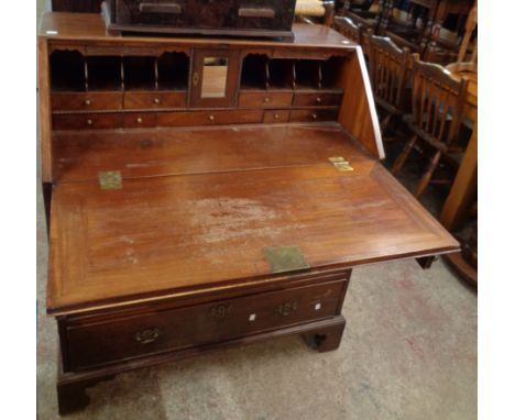 A 36 1/4" 19th Century mahogany bureau with fully fitted interior and four long graduated drawers under, set on bracket feet
