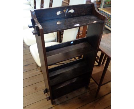 A 20 1/2" early 20th Century stained oak four shelf open bookcase with pierced raised back and pegged standard ends