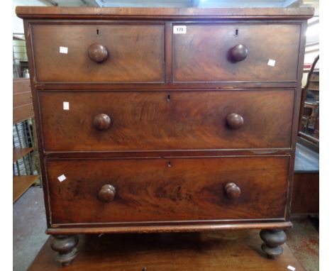 A 3' 3" 19th Century flame mahogany veneered chest of two short and two long graduated drawers, set on turned feet