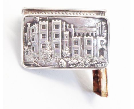 A Victorian silver vinaigrette with castle decoration to hinged lid, engine turning and initials to base, gilt interior with 