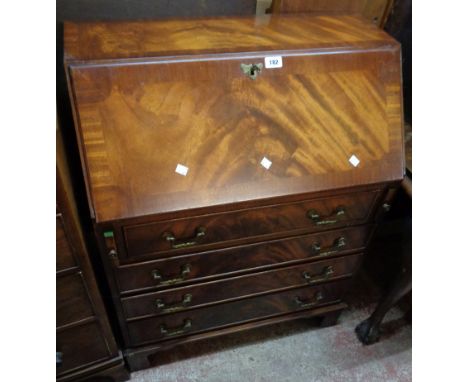 A 29 1/2" reproduction flame mahogany and cross banded bureau with fitted interior and four long graduated drawers under, set