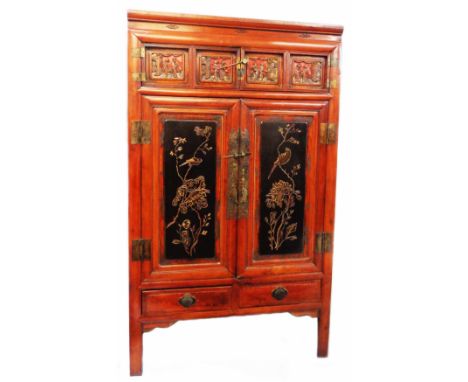 A 3' 3" Chinese lacquered wood cabinet with figural inset panels to small cupboard doors, over a pair of larger panelled door