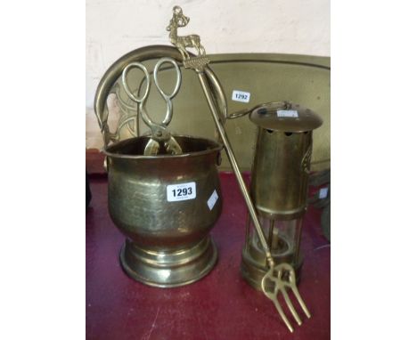 A reproduction miner's lamp, small coal scuttle, fork and tongs