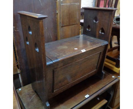 A 29 1/2" early 20th Century polished oak locker bench, with triple heart pierced standard ends and applied moulding to front
