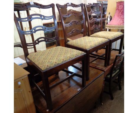 A set of four antique Chippendale style mahogany framed pierced ladder back dining chairs with wide upholstered drop-in seats