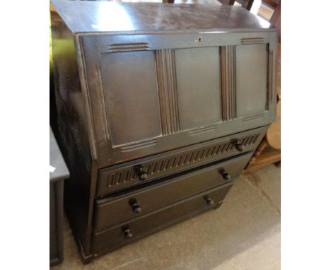 A 30" 20th Century stained oak bureau with part fitted interior and three long graduated drawers under