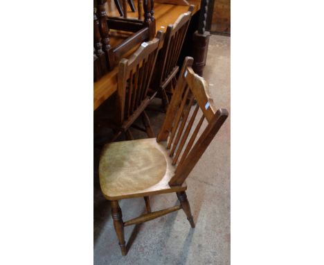 Three matching 19th Century pear wood stick back kitchen chairs with solid moulded seats, set on ring turned supports