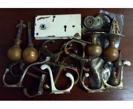 A collection of brass door knobs and hooks
