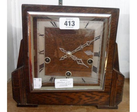 A mid 20th Century polished oak cased mantel clock with eight day Westminster chiming movement